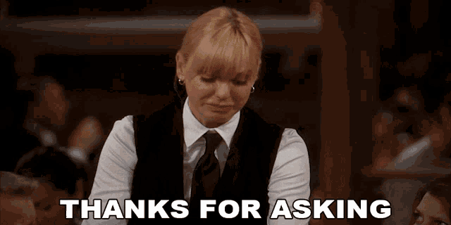 a woman in a vest and tie is crying and says thanks for asking