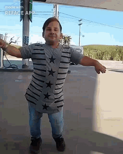a man is standing in a parking lot with his arms outstretched