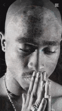 a close up of a man 's face with the letter m on the bottom right