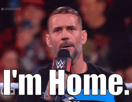 a man with a beard is talking into a microphone with the words i 'm home .