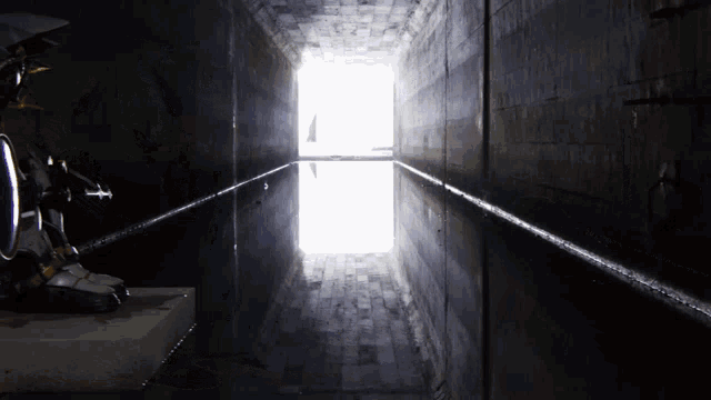 a dark room with a light at the end