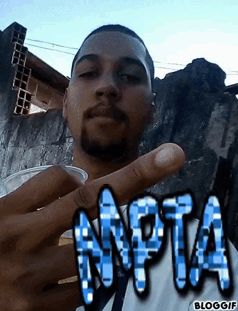 a man holding a cup with the word npta written in blue