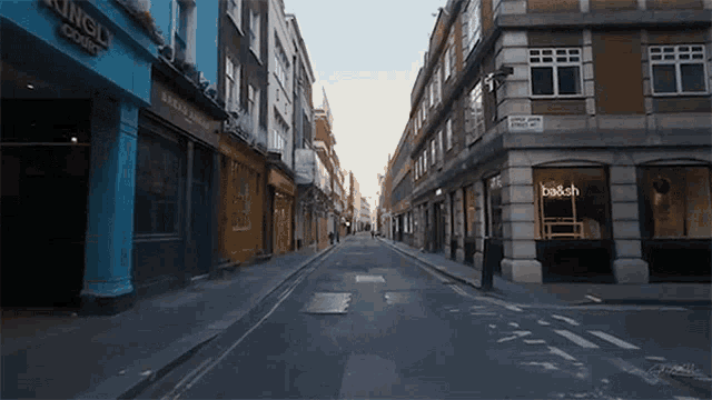 an empty street with a sign that says be & sch