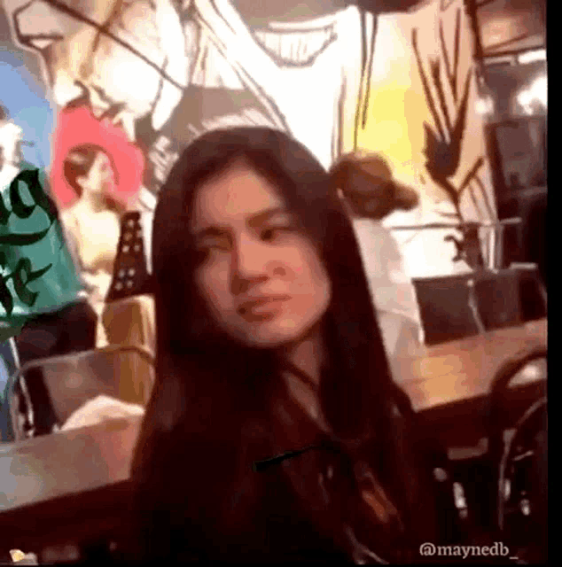 a woman 's face is shown in a blurry photo taken by @maynedb_