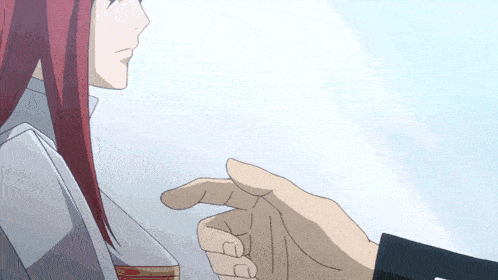 a woman with red hair is looking at a man 's hand which is pointing at her