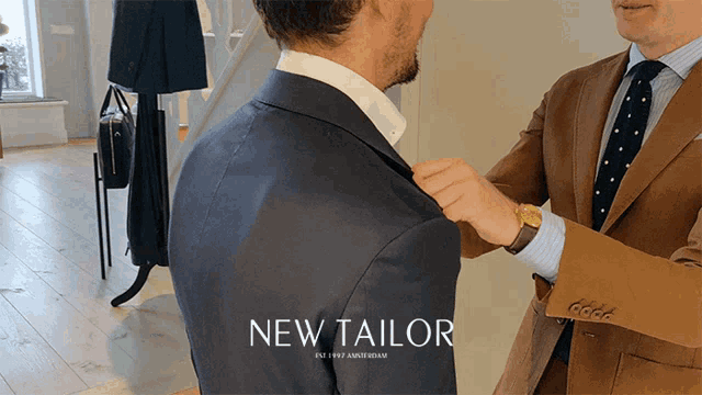 a man is getting his suit tailored by a tailor called new tailor