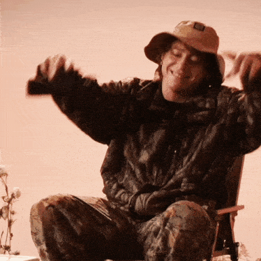 a man wearing a hat and a jacket with the letter g on it