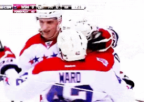 a hockey player named hard is hugging another hockey player