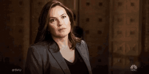 a woman in a suit stands in front of the words " what "