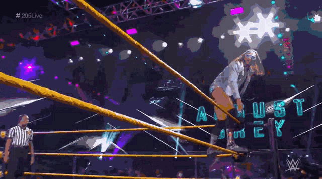 a wrestler in a ring with the words august written on the ring