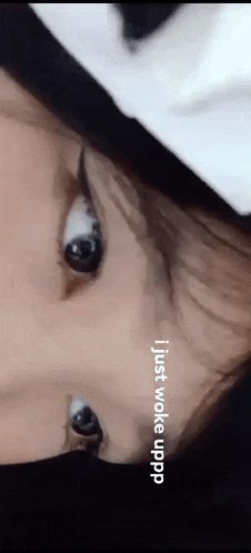 a close up of a person 's face with the words " i just woke uppp " written below it