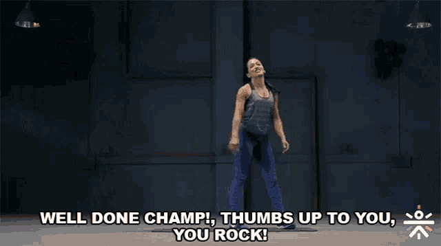a woman is standing with her hands on her hips and says " well done champ thumbs up to you you rock "
