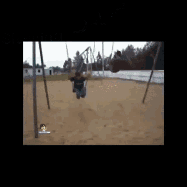 a person is laying on the ground while swinging in a playground