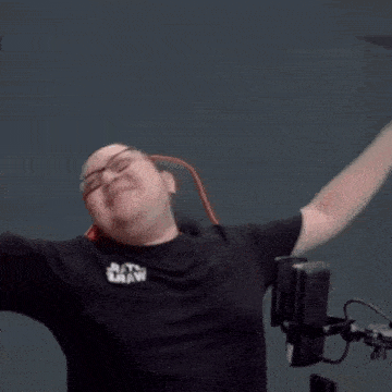 a man wearing glasses is sitting in a chair with his mouth open and his eyes closed .