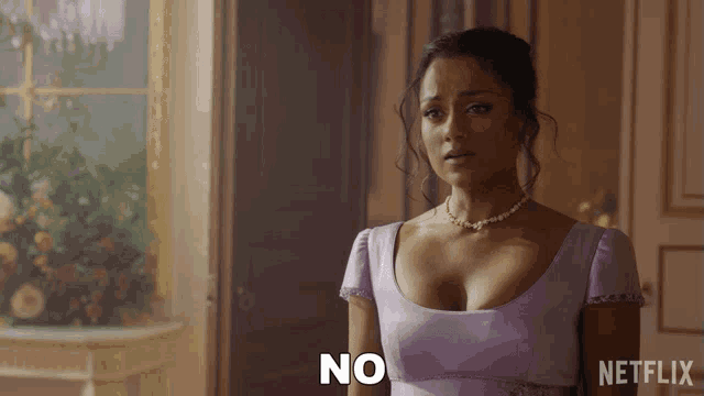 a woman in a purple dress and pearls says no