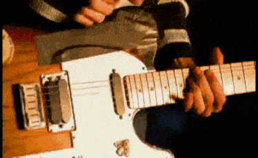 a man is playing an electric guitar with a butterfly on the neck .