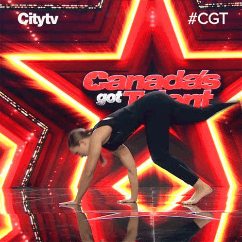 a woman is doing a handstand on a stage in front of a canada 's got talent star