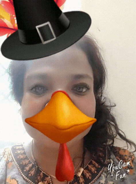 a woman is wearing a pilgrim hat and a turkey mask