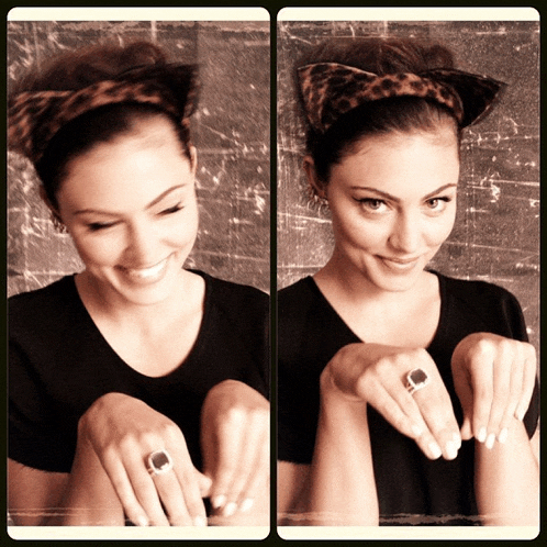 a woman wearing a cat ear headband shows off her ring
