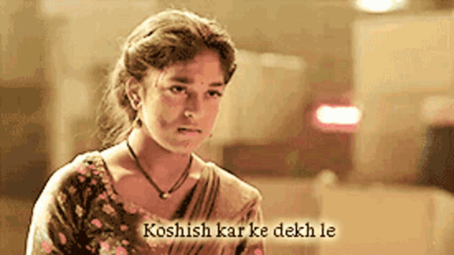a girl with the words koshish kar ke dekh le written on her face