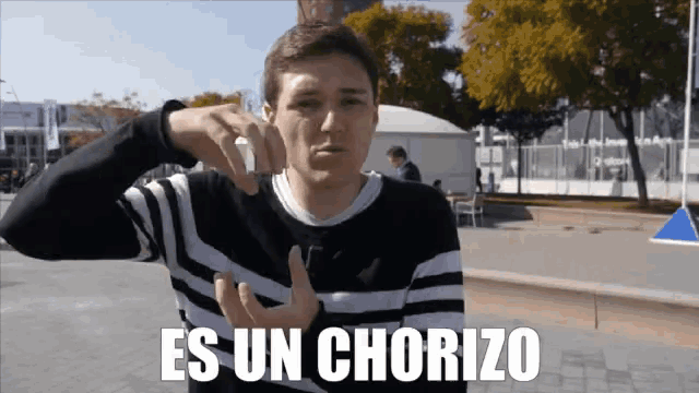 a man in a black and white striped sweater says " es un chorizo "