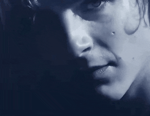 a close up of a person 's face with a tear coming out of his eye .