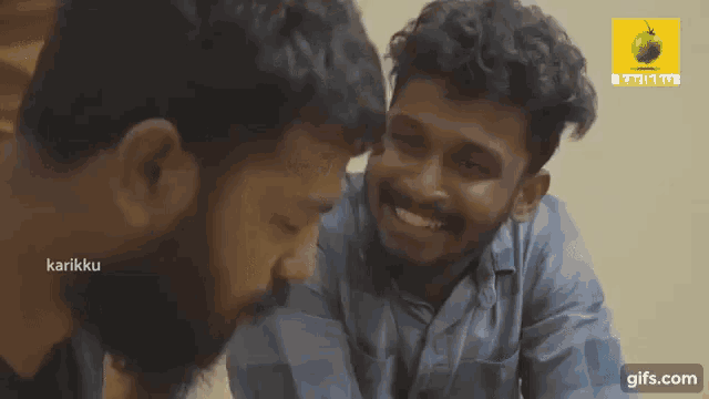 two men are smiling and looking at each other with a gifs.com logo in the background