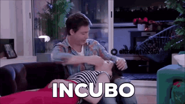a man and a woman are laying on a couch and the word incubo is visible