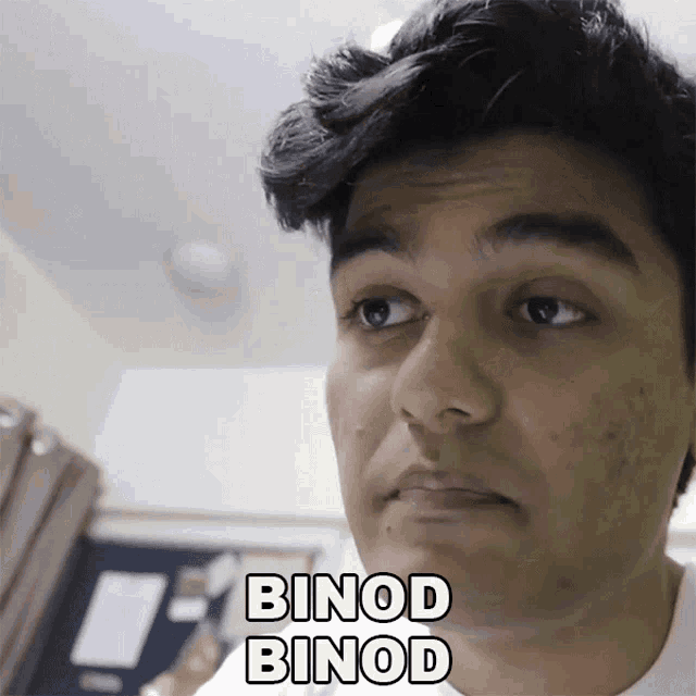 a close up of a man 's face with the words binod binod written on the bottom
