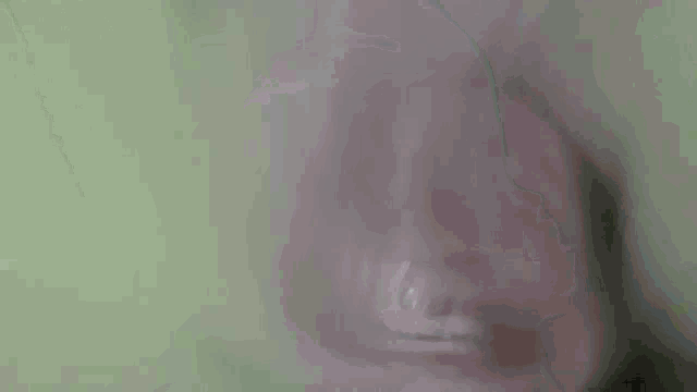 a close up of a person 's face in a dark room