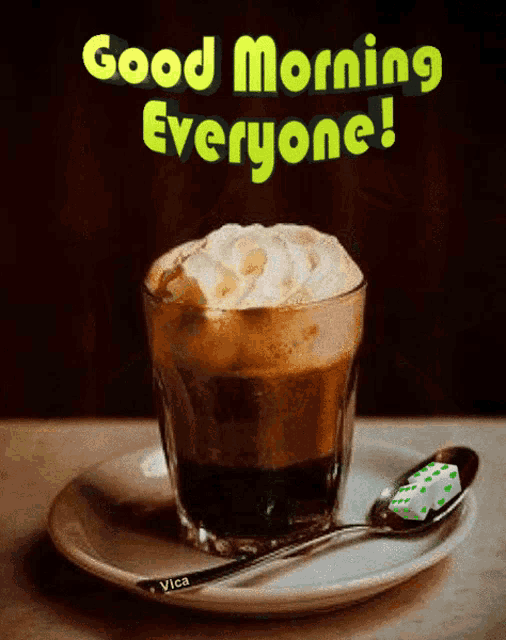 a cup of coffee with whipped cream and a spoon on a saucer with the words good morning everyone above it