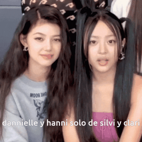 a couple of girls sitting next to each other with the words danielle y hanni solo de silvi y clari on the bottom