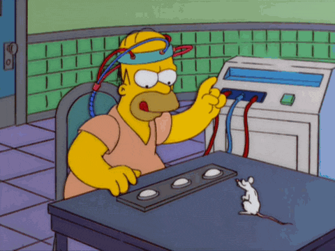 a cartoon of homer simpson sitting at a desk with buttons and a mouse