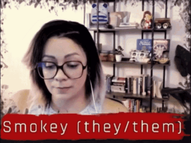 a woman wearing glasses and headphones with the words smokey ( they / them ) below her