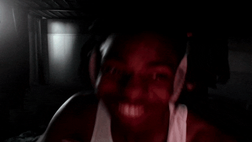 a blurry picture of a man in a white tank top