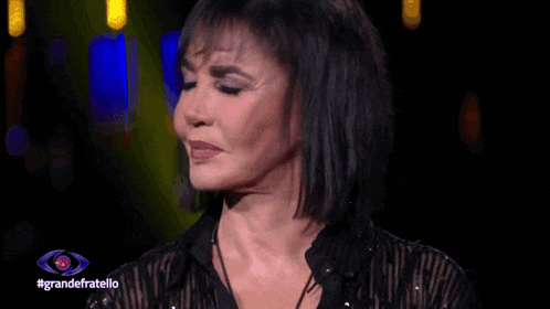 a woman 's face is shown in front of a large eye with the hashtag grandefratello