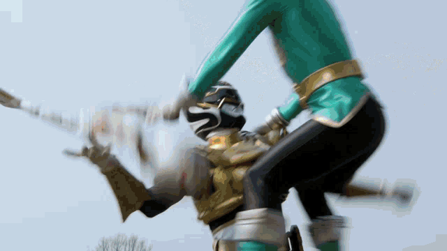 a blurred image of a person in a green outfit holding a sword