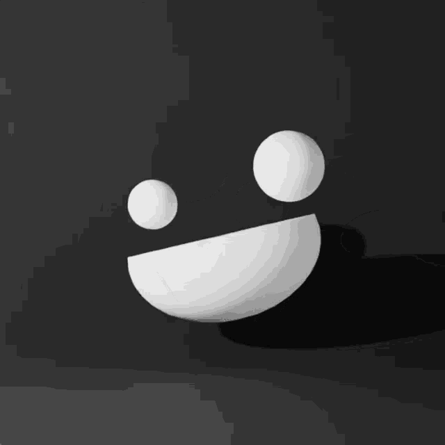 a black and white drawing of a smiley face with two white balls