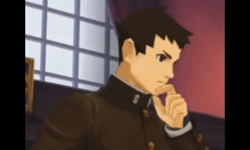 a man in a brown suit has a letter t on his chest