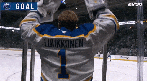 a hockey player in a blue and white jersey with the number 1 on it