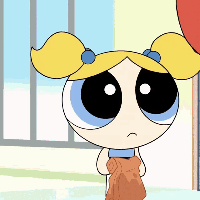 bubbles from the powerpuff girls is holding a brown towel