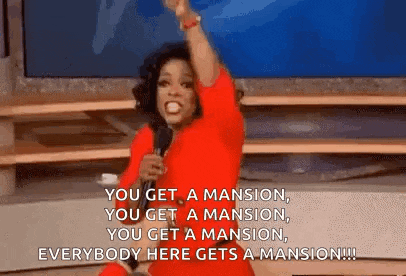 a woman in a red dress is standing in front of a microphone and holding her fist in the air .