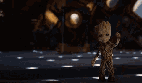 a woman is holding a gun and dancing in front of a full moon