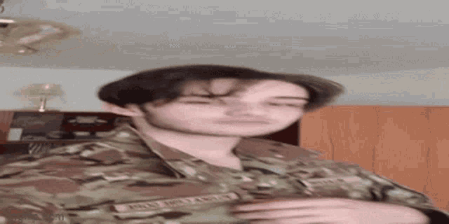 a young man in a military uniform has the name pikey on his chest .