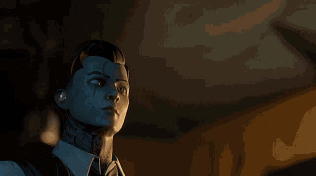 a man with a tattoo on his face is looking at something in a dark room