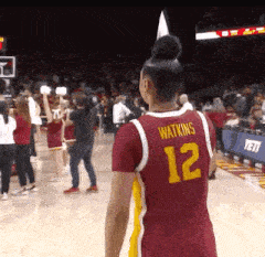 a female basketball player wearing the number 12