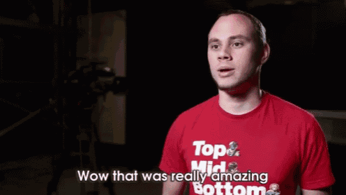 a man wearing a red t-shirt that says wow that was really amazing