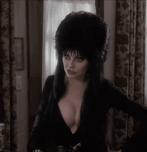 a woman wearing a black dress and a black hat
