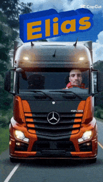 a man driving a mercedes truck with the name elias on top of it
