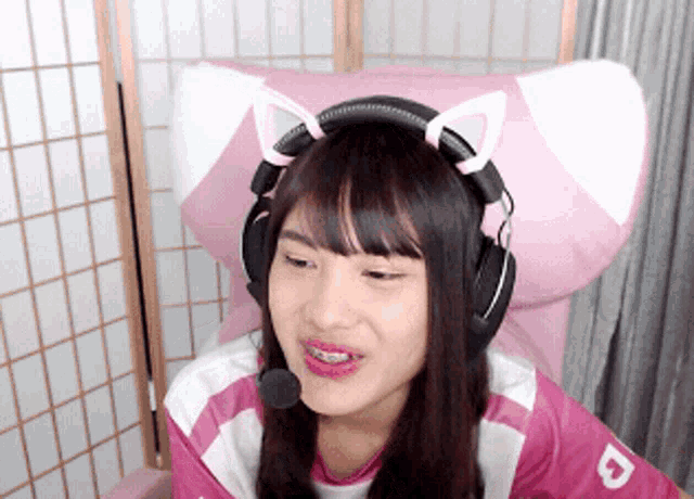 a girl wearing headphones and a shirt with the letter d on the arm